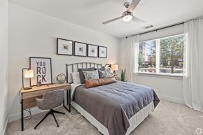 Mansfield apartment for rent - A bedroom with a bed, desk, chair, and pictures on the wall.