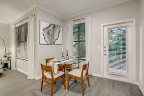 Austin apartment for rent - A dining room with a table set for two and a plant on the side table.