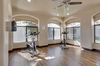 A room with a wooden floor and a ceiling fan.