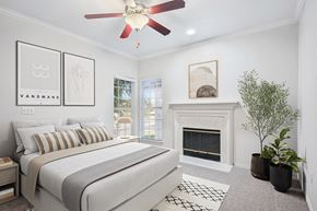 Plano apartment for rent - a bedroom with a bed and a fireplace at La Ventura Apartments, Plano, Texas