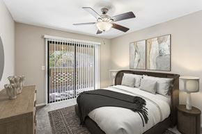 Mesa apartment for rent - A bedroom with a large bed and a ceiling fan. at San Montego Apartments, Mesa, AZ, 85206