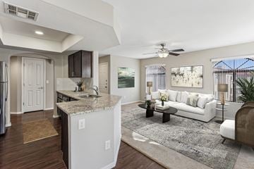 Mesa apartment for rent - A modern kitchen with a white island and a white sofa in the living room.