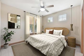 A bedroom with a large bed and a ceiling fan