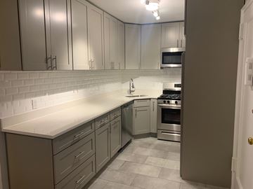 Hartsdale apartment for rent - A kitchen with white cabinets and a white countertop.