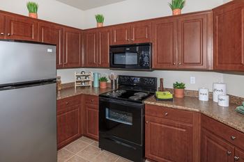 Kitchen with black appliances and brown cabinets