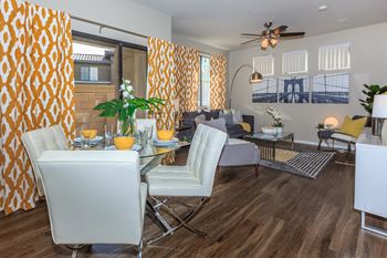 A living room and dining room with a table and chairs