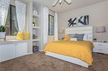 A bedroom with a yellow bed and a yellow blanket