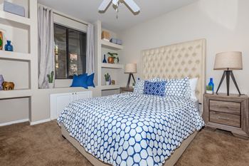 A bedroom with a bed and a window