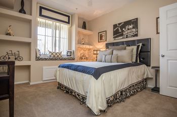 A bedroom with a bed and a window