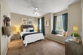 Las Vegas apartment for rent - A bedroom with a large bed and a ceiling fan.