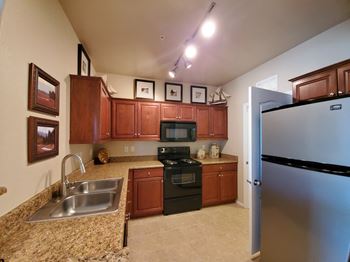 A kitchen with stainless steel appliances and granite counter tops