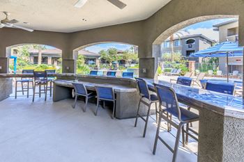 Patio bar with seating and tables with umbrellas
