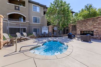 Pool and hot tub with chairs and a building