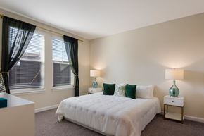 Bradenton apartment for rent - a bedroom with a white bed and green pillows  at The Oasis at Manatee River, Florida