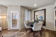 Las Vegas apartment for rent - A dining room with a table set for two and a view of a door with blinds.