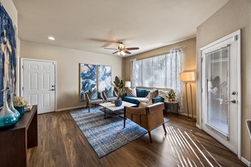 Las Vegas apartment for rent - A living room with a blue rug and a wooden floor.