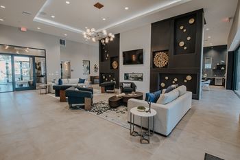 Spacious clubhouse with high ceiling, lots of cozy seating, and fireplace
