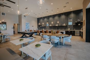 Resident clubhouse with pool table, fire place, lounge seating, long bar