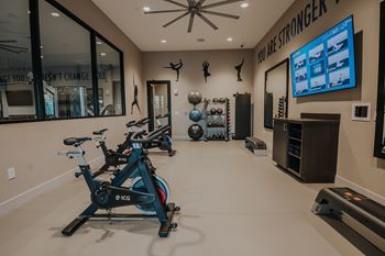 Spacious fitness center with cardio machines and weights