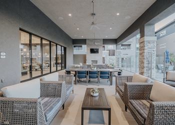 Modern outdoor living space with a dining table and chairs