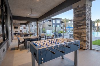 Foosball table on a large patio overlooking the pool