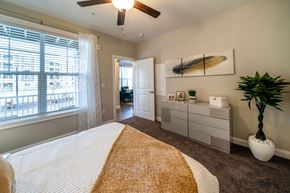 Plymouth apartment for rent - the preserve at ballantyne commons bedroom with a bed and a ceiling fan at The Oasis at Plymouth, Plymouth