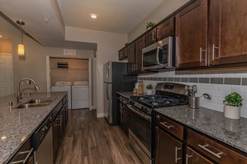 Redesigned kitchen with granite countertops and stainless steel appliances and wooden cabinets