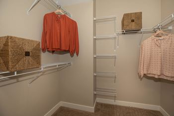 A walk in closet with racks and a shirt hanging on a rack