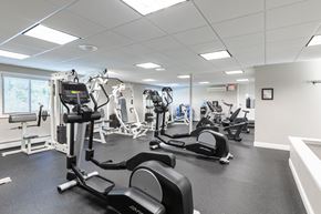 Warwick apartment for rent - A gym with treadmills, elliptical machines, and other exercise equipment.