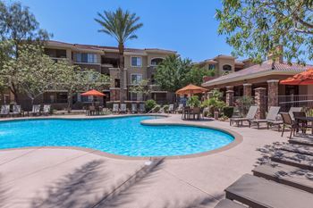 Swimming pool area with shaded chairs
