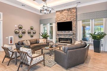 Fort Myers apartment for rent - a living room with couches and chairs and a fireplace