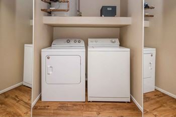 A combination washer and dryer in a laundry room with a shelf above them