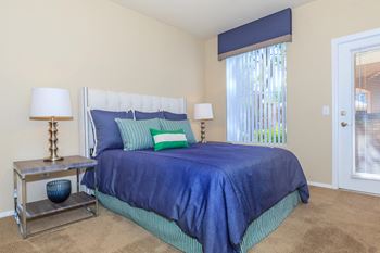 A bedroom with a bed and a window