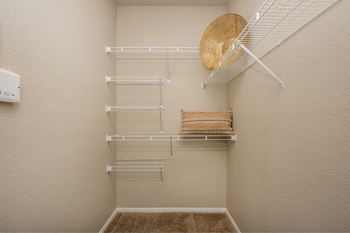 A small pantry with a white fridge and shelves.