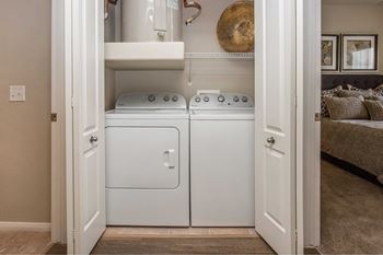 A washer and dryer in a small laundry room