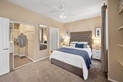 Las Vegas apartment for rent - A bedroom with a large bed and a ceiling fan. at The Fairways by Picerne Apartments, Las Vegas, NV, 89141
