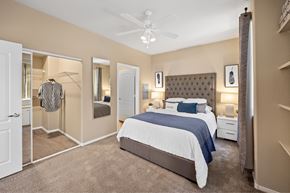 Las Vegas apartment for rent - A bedroom with a large bed and a ceiling fan. at The Fairways by Picerne Apartments, Las Vegas, NV, 89141