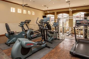A gym with treadmills and other exercise equipment