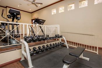 The gym with weights and equipment at 1861 muleshoe road
