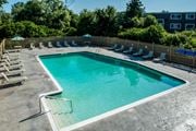 Middletown apartment for rent - A small pool surrounded by a wooden fence and lounge chairs.
