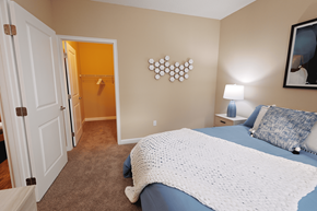 Orlando apartment for rent - a bedroom with a bed and a door to a bathroom at The Oasis at Moss Park, Orlando, FL
