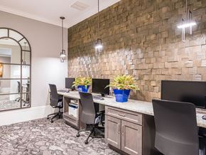 Zephyrhills apartment for rent - A modern office with a brick wall and a desk with a computer.