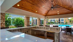 Zephyrhills apartment for rent - A modern outdoor kitchen with a pool.