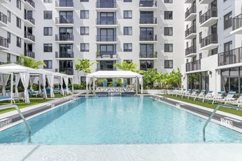 Tropical pool deck with large sundeck and cabanas