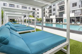 Tropical pool deck with large sundeck and cabanas