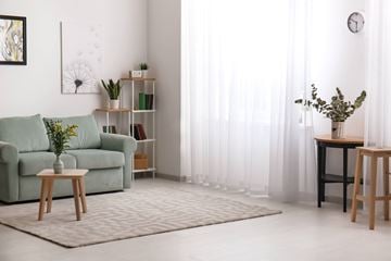 Alexandria apartment for rent - A living room with a green couch, a wooden table, and a painting on the wall.