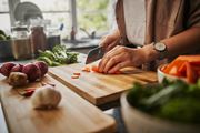 Alexandria apartment for rent - A person is chopping vegetables on a wooden cutting board.