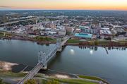 Alexandria apartment for rent - A bridge spans a body of water with a city in the background.