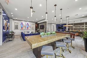 Houston apartment for rent - Spacious resident lounge with comfortable seating and vibrant artwork at Allusion at West University apartments in Houston, TX