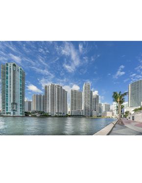 North Miami Beach apartment for rent - A row of modern buildings line a waterfront.